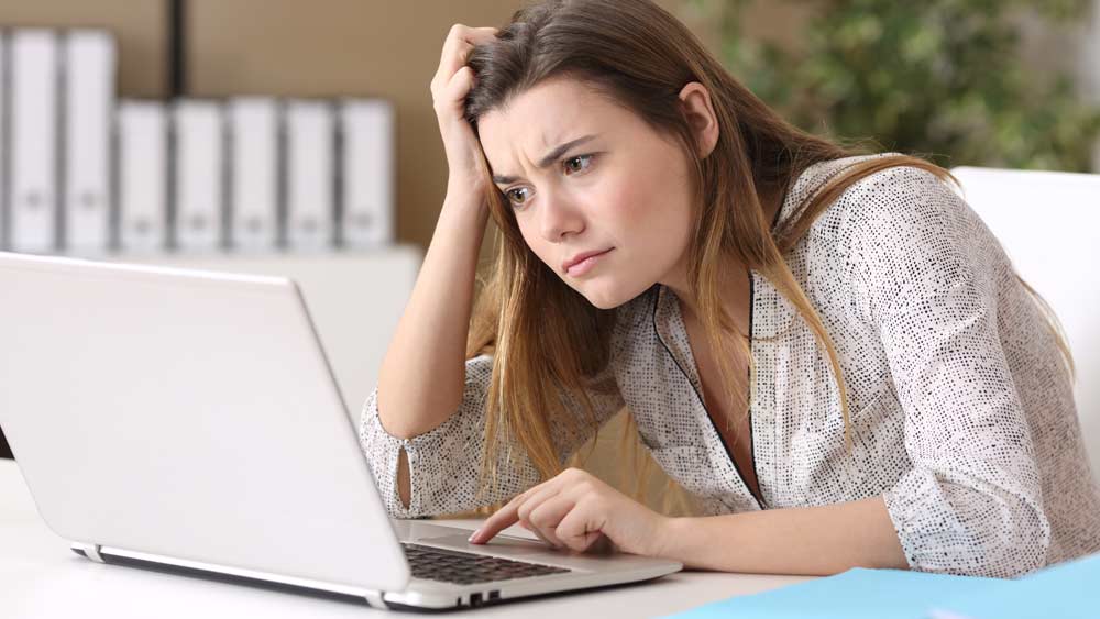 Frustrated woman working on computer